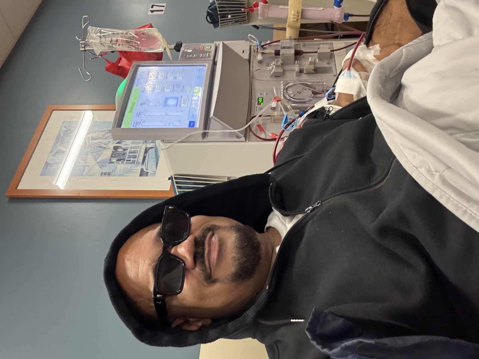 Michael Moore receiving hemodialysis at his clinic — seated at station 17, dialysis machine and access lines visible